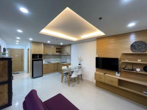 a living room with a kitchen with a dining table at Patong Tower Condominium by Lofty in Patong Beach