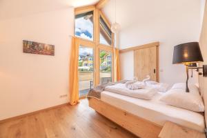 a bedroom with a bed with a large window at Chalet Oxygen in Fürth