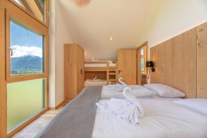 a bedroom with two beds and a large window at Chalet Oxygen in Fürth