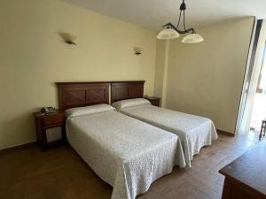 Postel nebo postele na pokoji v ubytování Hotel Casa Beletri