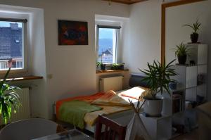 a room with a bed and two potted plants in it at Seraphine in Tauplitz