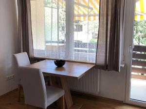 een tafel en stoelen in een kamer met een raam bij Ferienwohnung Grüßer in Bad Reichenhall