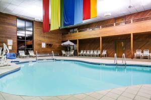 a large pool in a hotel with a rainbow flag at Days Inn & Suites by Wyndham Wausau in Wausau