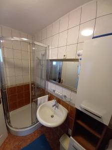 a bathroom with a sink and a shower at Apartman BoloB in Baška