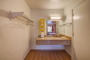 a bathroom with a sink and a large mirror at Motel 6-Norfolk, VA in Norfolk