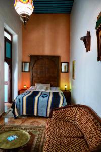 A bed or beds in a room at Riad Khmisa