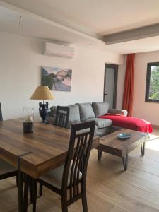 a living room with a table and a couch at Oceland Suites Gamboa in Praia