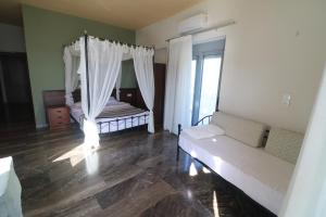 a bedroom with a bed and a dresser at Horizon Beach Hotel in Plakias