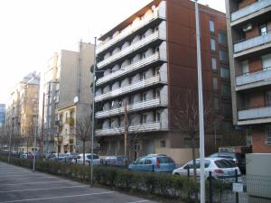 a parking lot with cars parked in front of an apartment building at Apartment4you Budapest in Budapest