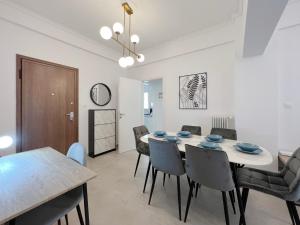 comedor con mesa blanca y sillas en Mouson Modern 80sqm apt next to Edem beach, en Atenas