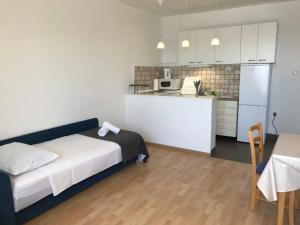 a small room with a bed and a kitchen at Apartmani Silvano in Murter +37 photos