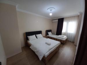 Ein Bett oder Betten in einem Zimmer der Unterkunft Kıvanç Residence