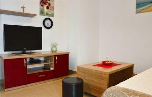 a living room with a flat screen tv on a cabinet at Apartmani Obala in Promajna