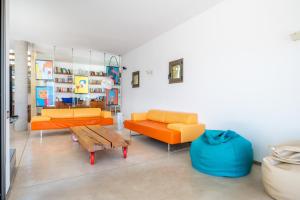 a living room with two orange couches and a table at Herce Property - Minimalist & Mediterranean in Llucmajor