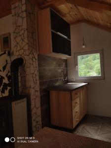 a kitchen with a sink and a window at Private accommodation Kalezić in Mojkovac