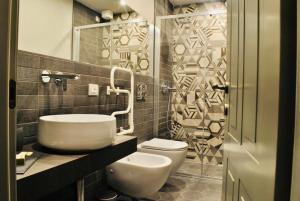 a bathroom with a white toilet and a sink at Locanda San Tomaso Affittacamere in Pietra Ligure