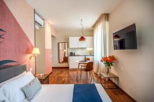 a hotel room with a bed and a kitchen at Milhouse Suites Duomo in Milan