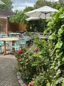 a patio with a table and chairs and an umbrella at The Coach and Horses in Oxford