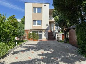 a house with a brick driveway in front of it at Ubytovanie Zobor in Nitra