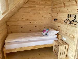 a wooden cabin with a bed in a room at Na starej drodze in Ciche