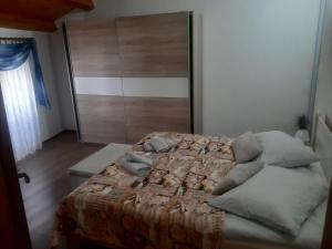 a bedroom with a bed and a closet at Sant Elena in Bale