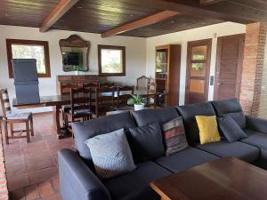 a living room with a couch and a dining room at Casa Calvés in Aviá