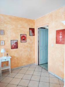 a room with a blue door and paintings on the wall at Maison de village - Suite Baroque cosy et élégante à 1 h de Paris proche Fontainebleau 