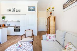 a living room with a couch and a table at GuestReady - Lovely apartment Place de la Bourse in Bordeaux