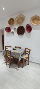 a table and chairs with plates on a wall at Casa Diana in Augusta