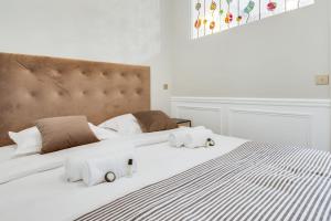 a bedroom with a large white bed with towels on it at GuestReady - Lovely flat in Central Paris near Notre-Dame in Paris