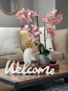 a welcome sign on a coffee table in a living room at OU-2 bed 2 bath apartment close to OU in Oklahoma City