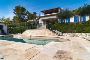a house with a swimming pool in front of a house at Villa Thalia in Moissac-Bellevue