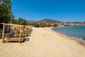 a row of lounge chairs on a beach at Cavos in Agios Sostis