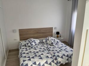 a bedroom with a bed with two pillows on it at Bungalow Yumbo in Playa del Ingles