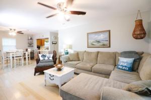 a living room with a couch and a table at SUNNY DAZE Walk to Beach 2 Decks Pet Friendly Has a Mini Bar in Galveston