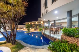 an image of a swimming pool in a hotel at night at Hotel Porto Napolis in Eunápolis