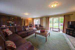 a living room with a couch and a coffee table at Errichel House and Cottages in Aberfeldy