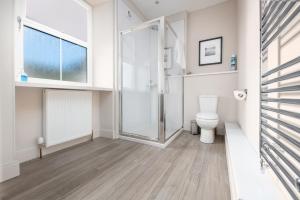 a bathroom with a shower and a toilet at The Cottage, The Loch Ness Cottage Collection in Inverness +13 photos