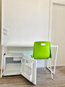 a green chair sitting in front of a desk at BRIBANO HOSTEL & bike sharing-workers and tourists hospitality in Sedico