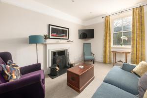 a living room with a couch and a fireplace at The Cottage, The Loch Ness Cottage Collection in Inverness