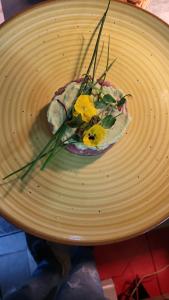 a plate of food on a table with flowers on it at Bucharest Great Luxury ApartHotel ParkLake in Bucharest
