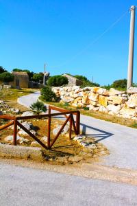 a wooden bench sitting on the side of a road at Ai piedi di Cofano in Custonaci
