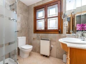 a bathroom with a toilet and a sink and a window at Casa Gallito, By DaiMar in Granada +34 photos