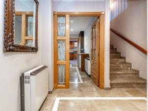 a hallway with stairs and a mirror in a house at Casa Gallito, By DaiMar in Granada