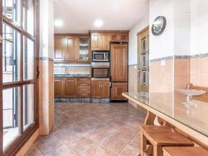a kitchen with wooden cabinets and a counter top at Casa Gallito, By DaiMar in Granada