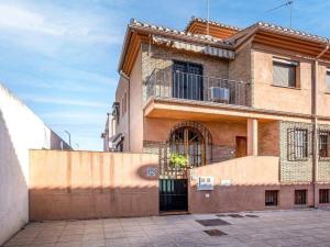 a large brick building with a gate in front of it at Casa independiente en Granada in Granada