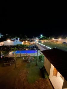 a view of a resort at night with lights at POUSADA CENÁRIO IDEAL in Icapuí