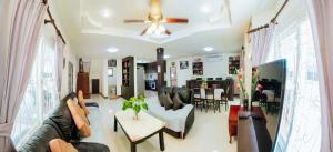 a living room with a couch and a table at Captivating 3-Bed Villa in Muang Pattaya in Nong Prue