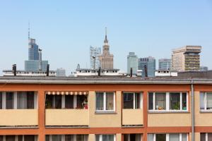 a building with windows and a city in the background at Apartaments Solec 79 by Renters in Warsaw