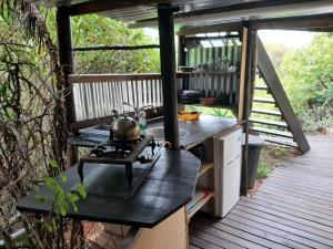 a kitchen on a deck with a stove at The Nest @ The Old Trading Post in Wilderness